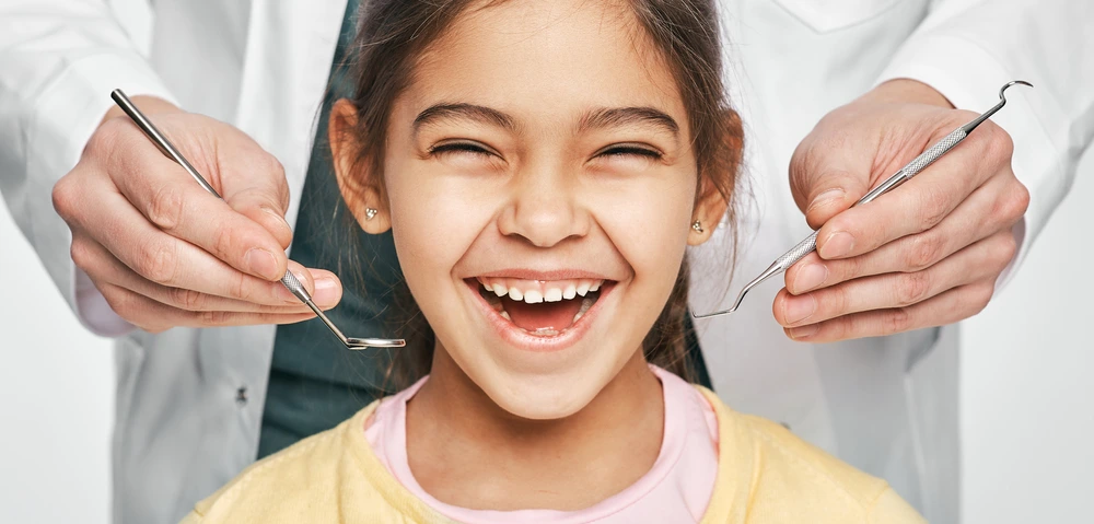 A young female patient of City Family Dental Care is smiling before her dental treatment