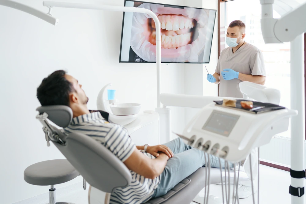 A male patient of City Family Dental Care is listening while his dentist is explaining the treatment