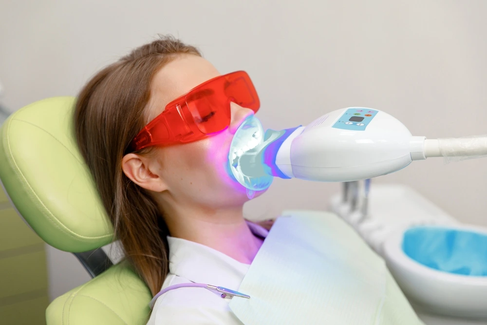 A female patient of City Family Dental Care is under teeth whitening treatment